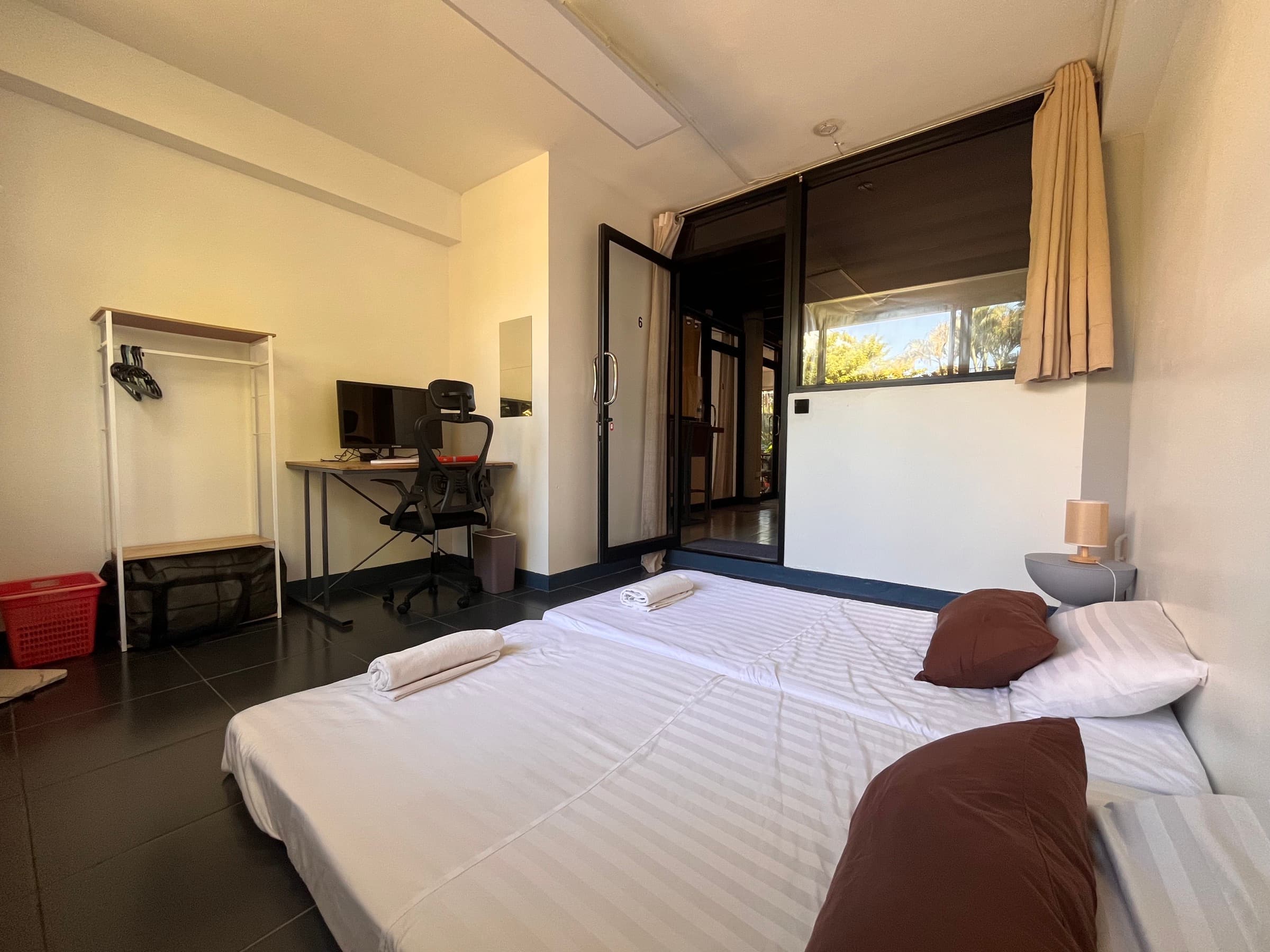 Queen-bed ground floor room with desk and brick walls